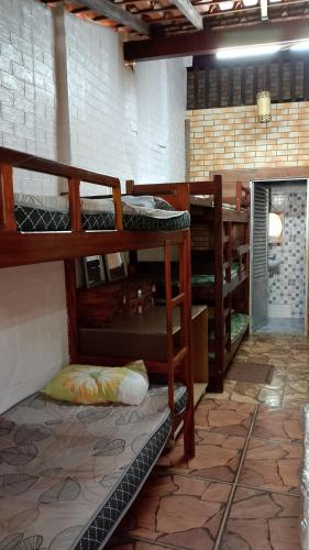 a room with several bunk beds in it at Pousada Angelical in Saquarema