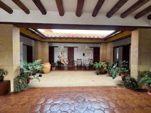 a large lobby with plants and a ceiling at Hotel Palais Barichara in Barichara