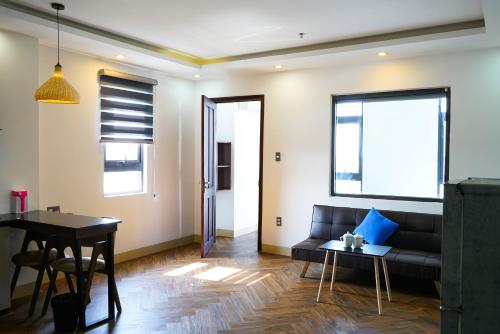 a living room with a couch and a table at Mama Hotel And Apartment - Free Sauna And Gym in Da Nang