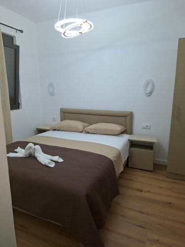 a bedroom with a bed with a towel on it at Vhtwins apartment in Ulcinj