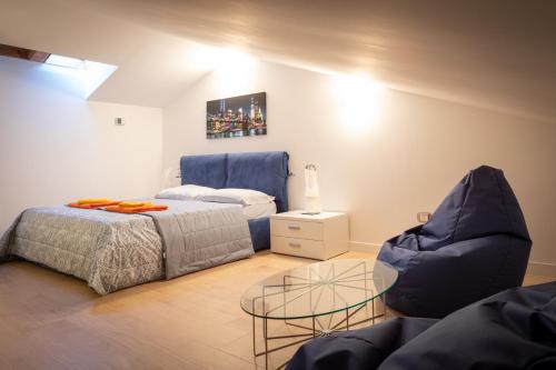 a living room with a bed and a glass table at Portopiccolo Avolare Apartment InRed - beach included in Sistiana