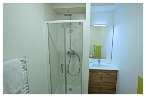 a bathroom with a shower and a sink at Résidence Napoléon in Ornolac-Ussat-les-Bains