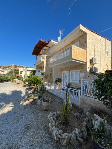 a house with a porch and a balcony at Nomads in the south in Tsoútsouros