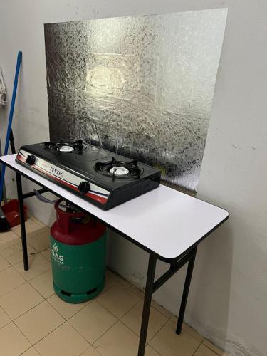 a stove sitting on a table in a room at NovaHaus2 Homestay Gong Badak in Kuala Terengganu
