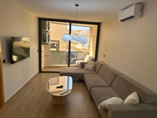 a living room with a couch and a table at Belle cote appartement al hoceima in Al Hoceïma
