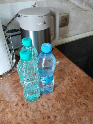two bottles of water sitting on top of a counter at Квартира 2 х комнатная in Dushanbe
