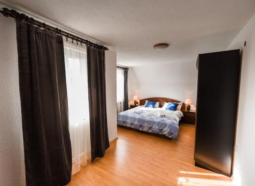 a bedroom with a bed and a large window at Holiday Home Sunset in Posušje