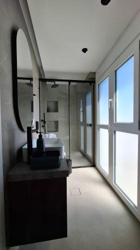 a bathroom with a sink and a mirror at Modern luxury apartments in Evia in Chalkida