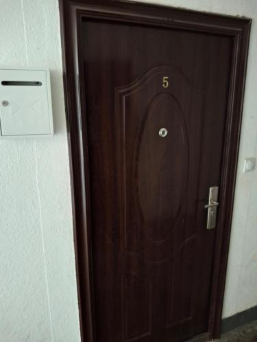 a wooden door with the number six on it at TI-NI Apartment in Gevgelija