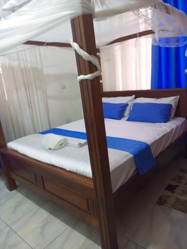 a bunk bed with blue and white pillows on it at Cozyblue fully furnished 1 bedroom bnb in Mombasa