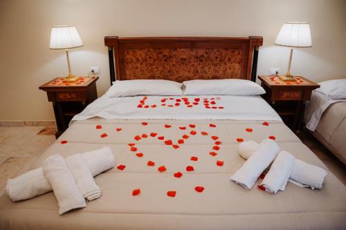 a bedroom with a bed with red hearts on it at La casa di Pippo in Foggia