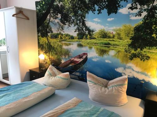 a room with a painting of a river and a boat at Ferienwohnung Zur Weißen Taube in Dobbertin