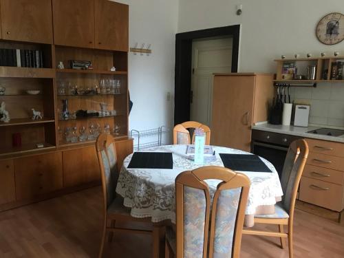a kitchen with a table with four chairs and a kitchenventory at Ferienwohnung Zur Weißen Taube in Dobbertin