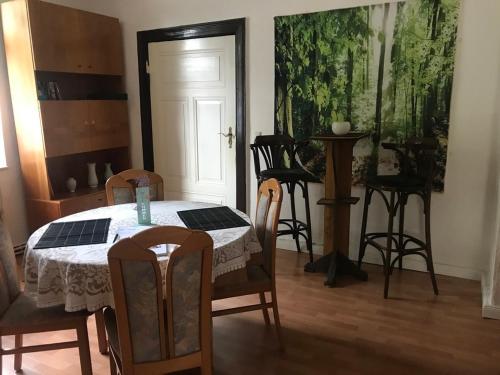 a dining room with a table and chairs and a door at Ferienwohnung Zur Weißen Taube in Dobbertin