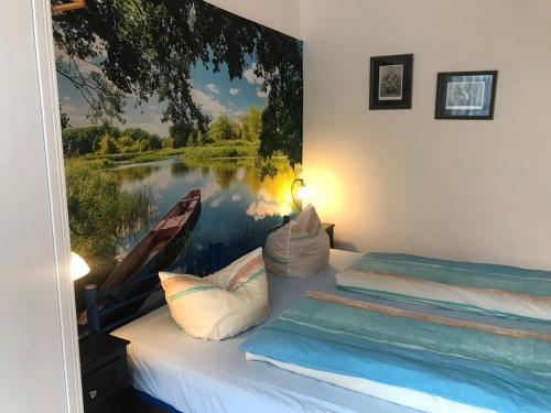 a bedroom with a painting of a boat on the wall at Ferienwohnung Zur Weißen Taube in Dobbertin