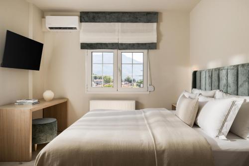 Ένα ή περισσότερα κρεβάτια σε δωμάτιο στο Meteoron Suites