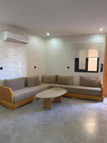 a living room with a couch and a table at Belle cote appartement al hoceima in Al Hoceïma