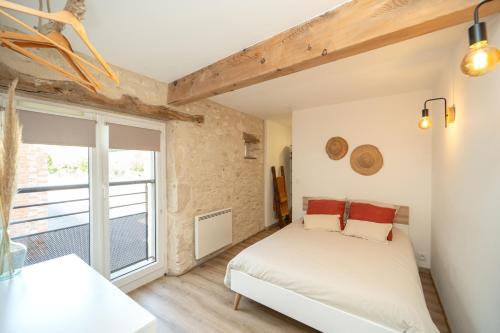 a bedroom with a bed and a large window at Maison de campagne avec salle de jeux 6 personnes in Cuq