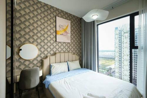 a bedroom with a bed and a chair and a window at VINHOMES GRAND PARK QUẬN 9 Căn hộ LUXURY MASTERI CENTRE POINT in Gò Công