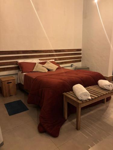 a bedroom with a large bed with a wooden headboard at Fazenda Brotas SP in Brotas