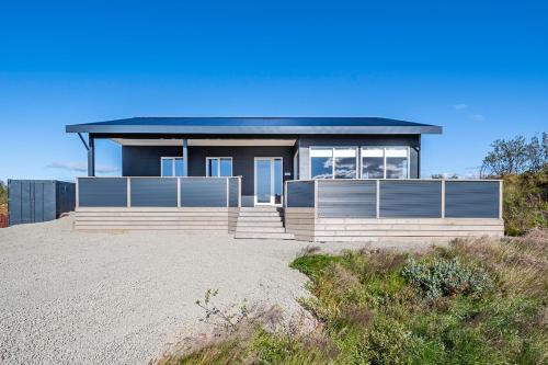 a house on top of a sandy beach at Luxury Villa in Golden Circle with hot tub in Selfoss
