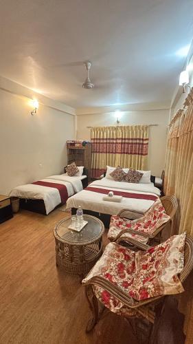 Una cama o camas en una habitación de Cherry Garden Pokhara