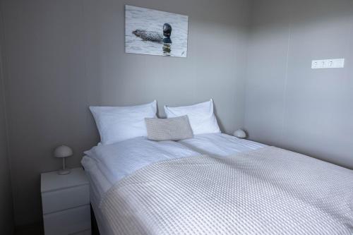 a bedroom with a bed and a picture of a duck on the wall at Luxury Villa in Golden Circle with hot tub in Selfoss