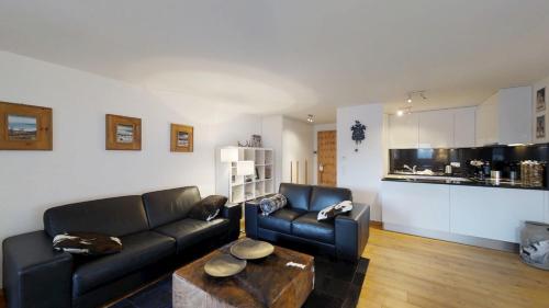 a living room with a couch and a table at Arsa 26 in Silvaplana