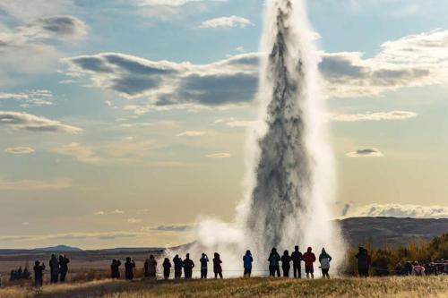 a group of people standing around a geyser at Luxury Villa in Golden Circle with hot tub in Selfoss