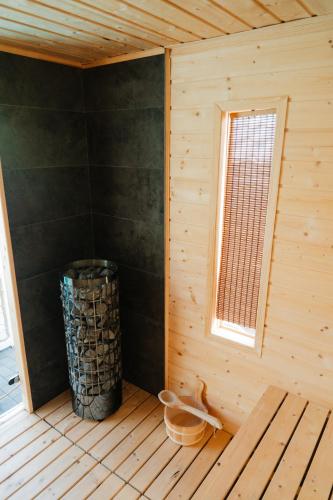 a corner of a wooden cabin with a window at Domki Wierzbówka in Mielno