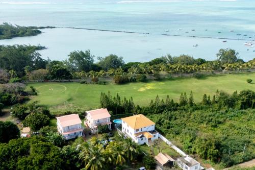 an aerial view of a resort with the water at Grand Gaube Golf Sea View Apartment in Mauritius