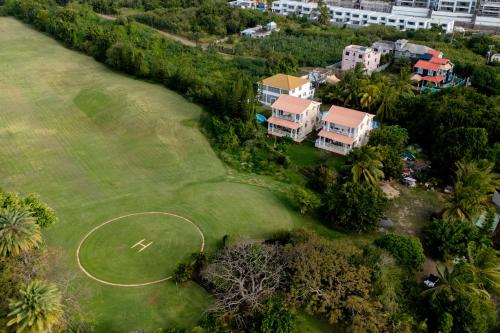 an aerial view of a house and a golf course at Grand Gaube Golf Sea View Apartment in Mauritius