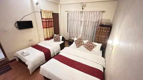 Voodi või voodid majutusasutuse Cherry Garden Pokhara toas
