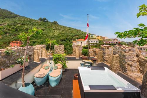a balcony with a hot tub on top of a mountain at Capitolare Suite Tower in Portovenere