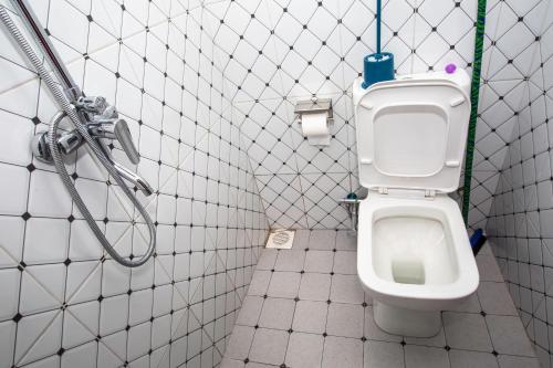 a bathroom with a toilet and a shower at Novella Guesthouse in Arua