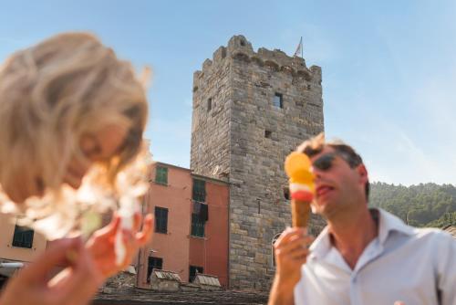 a man and a little girl eating ice cream at Capitolare Suite Tower in Portovenere