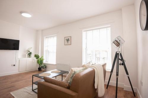 a living room with a couch and a table at Stylish 1 Bed Apartment in Penarth Town Flat 2 in Cardiff