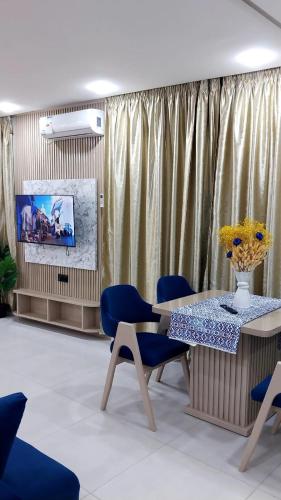 a room with a table and chairs and a tv at Studio Chefchaoun in Deroua