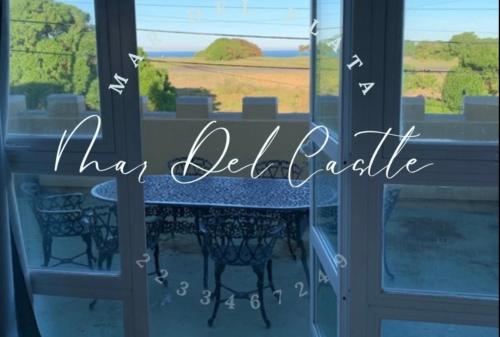 a table in a window with the wordsha delilus at Mar Del Castle in Mar del Plata
