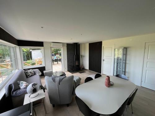 a living room with a white table and chairs at Modern Lakeside Hideaway in Örebro