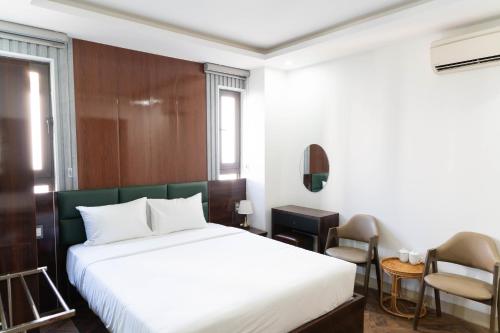 a hotel room with a bed and a chair at Mama Hotel And Apartment - Free Sauna And Gym in Da Nang