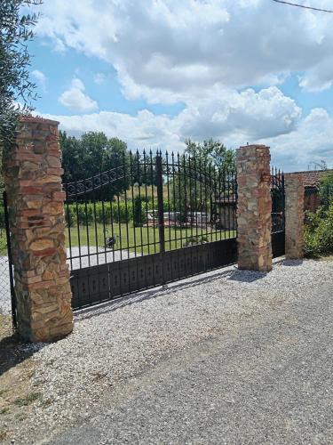 a black wrought iron fence with a gate at Casale - La Camera di Leda in Lamporecchio