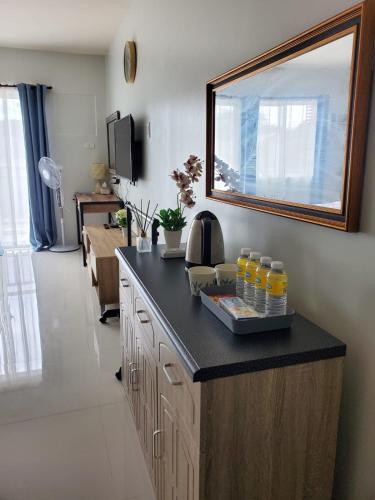 a kitchen with a counter with drinks on it at VERDANT by Vista Manors Deluxe Rooms with Balcony, Gym and Swimming Pool in Puerto Princesa City