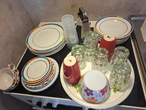 a table with plates and glasses on a shelf at Privat gästhus med egen trädgård in Kävlinge