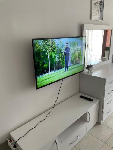a flat screen tv hanging on a wall at Sun&See in Durrës