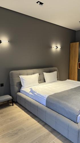 a bed with two pillows on it in a room at BOND HOUSE Dilijan in Dilijan