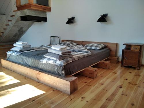 a bedroom with a bed with a wooden floor at Trafo Base Camp in Kroczyce