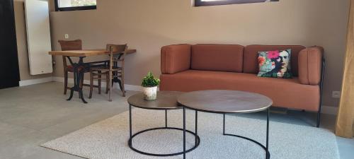 a living room with a couch and a table at 2 Gites dans les remparts à Dun sur Meuse in Dun-sur-Meuse