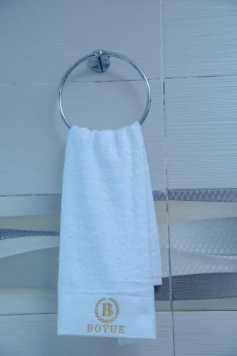 a towel hanging on a towel rack in a bathroom at 泊悦国际大酒店 BoYue Hotel in Addis Ababa Bole International Airport