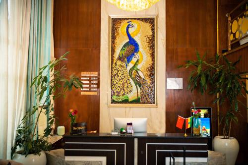 a lobby with a desk with a peacock painting on the wall at 泊悦国际大酒店 BoYue Hotel in Addis Ababa Bole International Airport